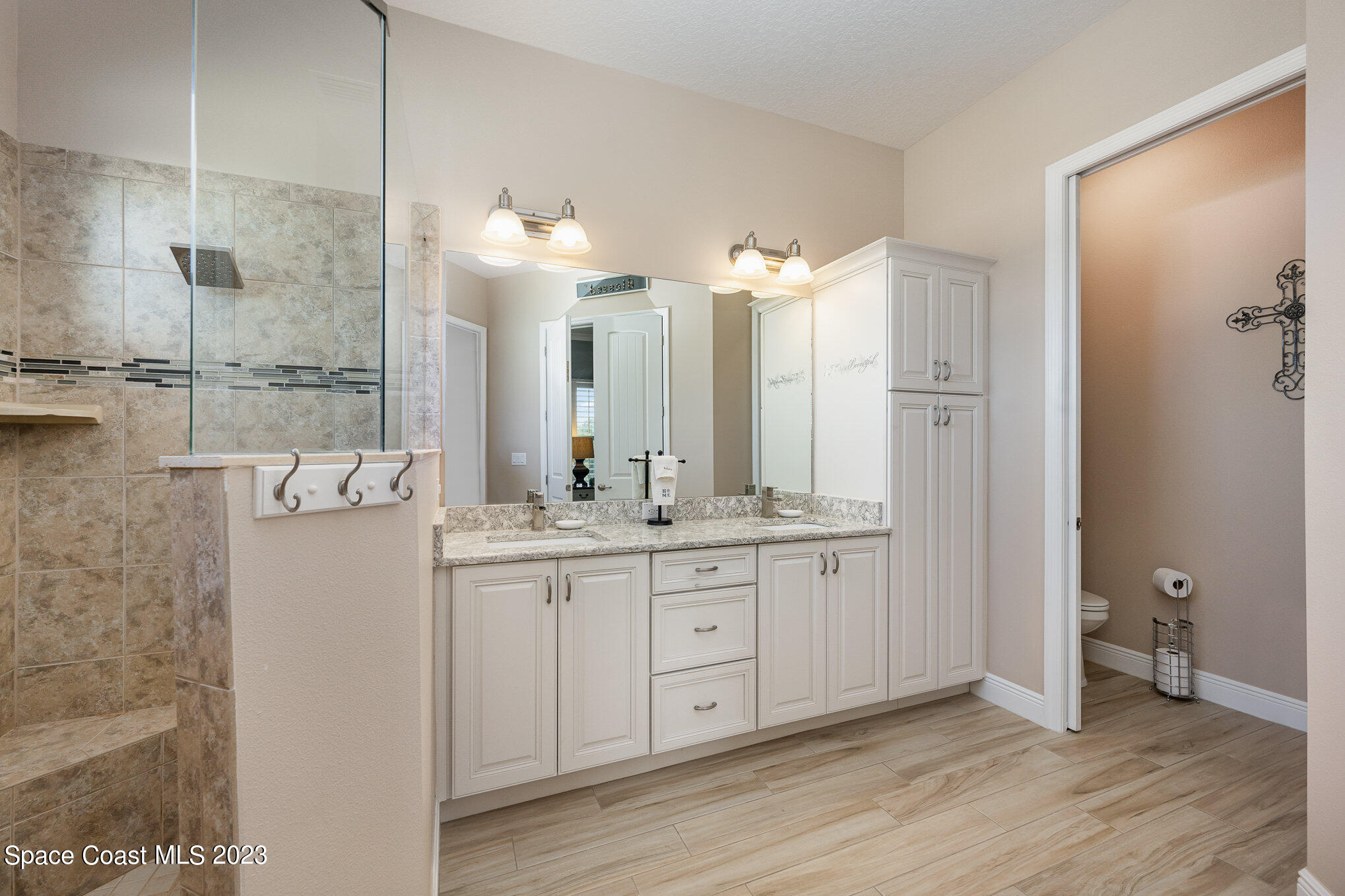 3850 Alamanda Key Drive Melbourne, FL 32901 - Photo 12 of 44 a bathroom with a double vanity sink and a mirror