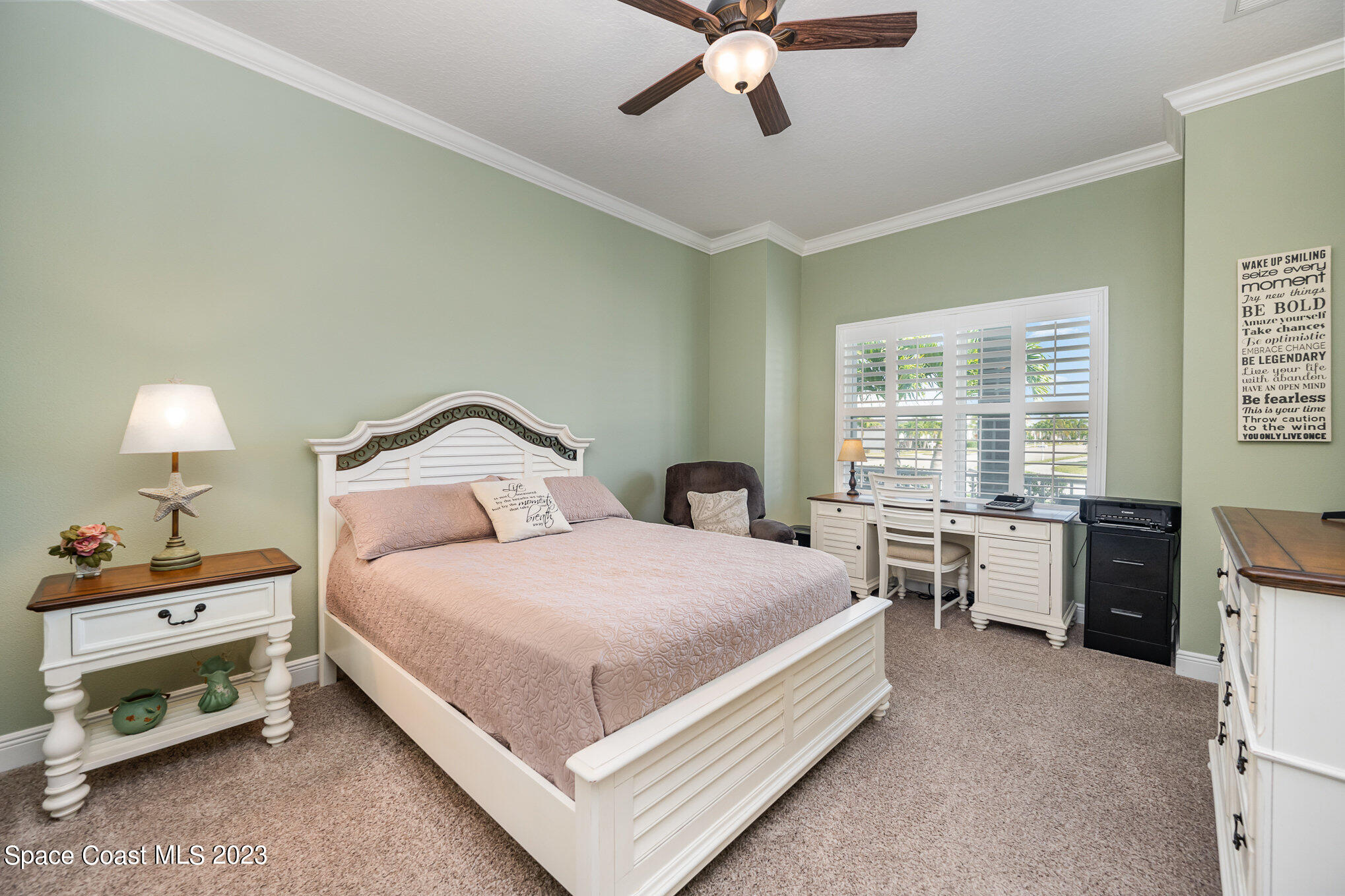 3850 Alamanda Key Drive Melbourne, FL 32901 - Photo 13 of 44 a bedroom with a bed and a chandelier