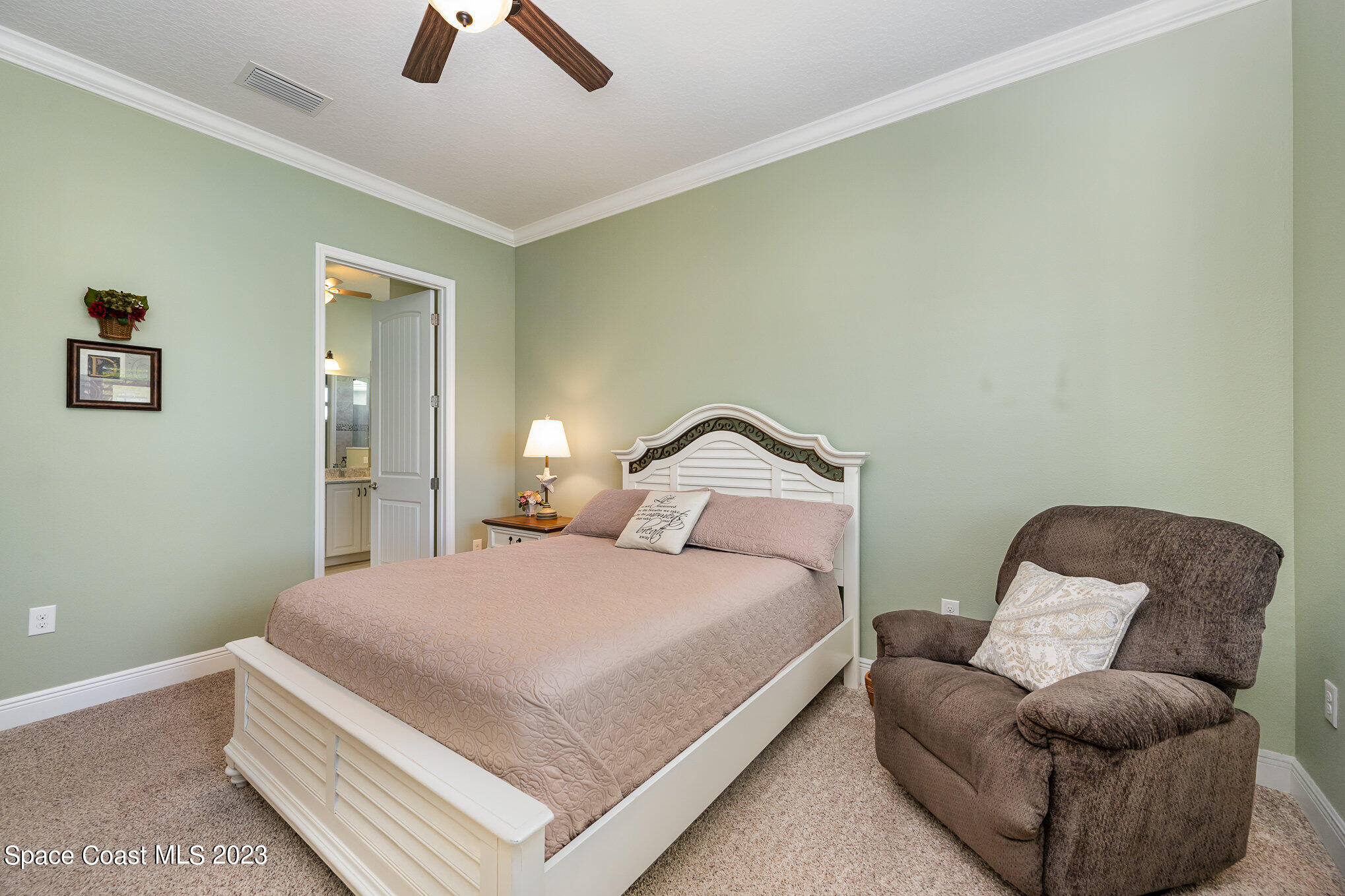 3850 Alamanda Key Drive Melbourne, FL 32901 - Photo 14 of 44 a bedroom with a bed and ceiling fan