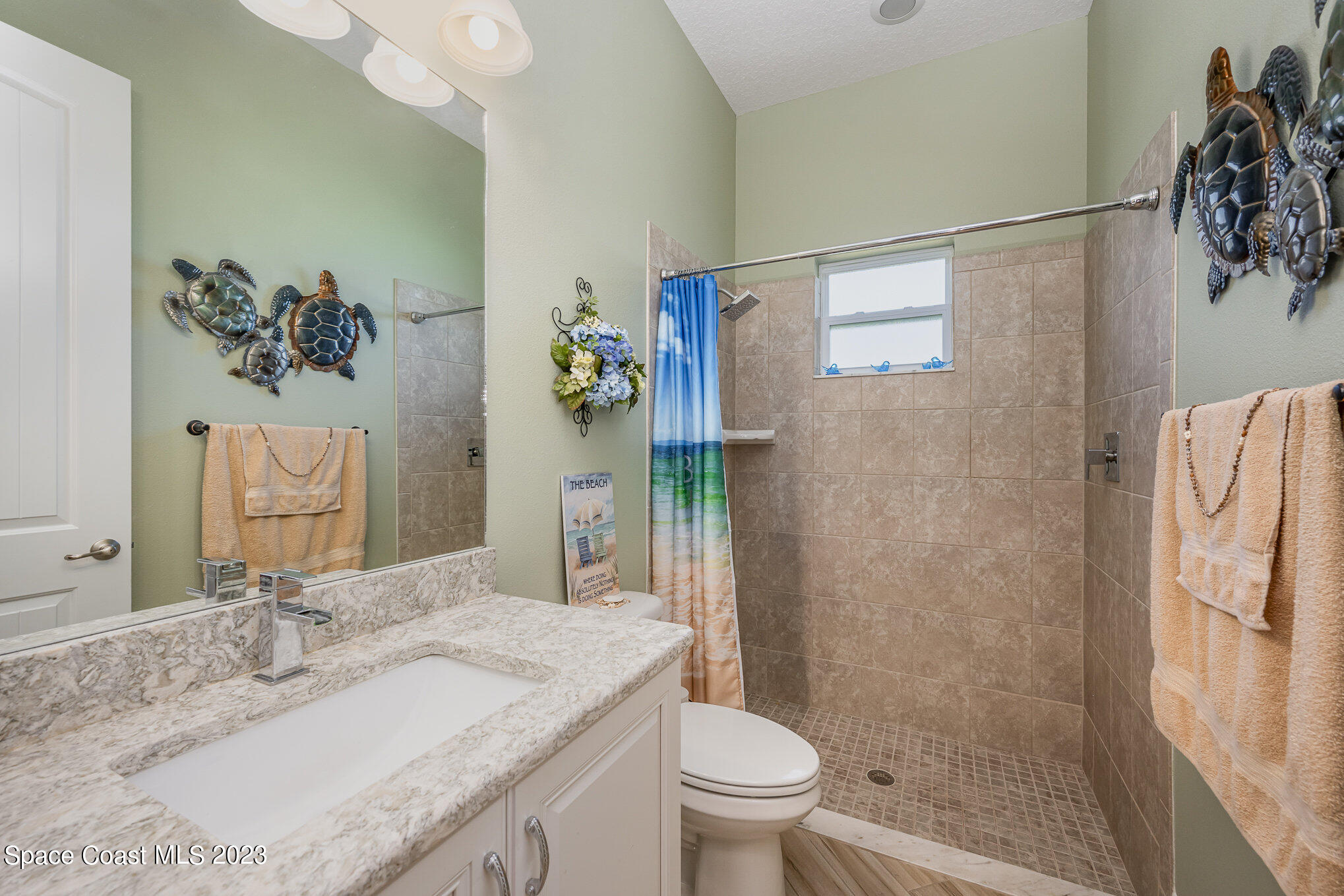 3850 Alamanda Key Drive Melbourne, FL 32901 - Photo 17 of 44 a bathroom with a granite countertop sink toilet and shower