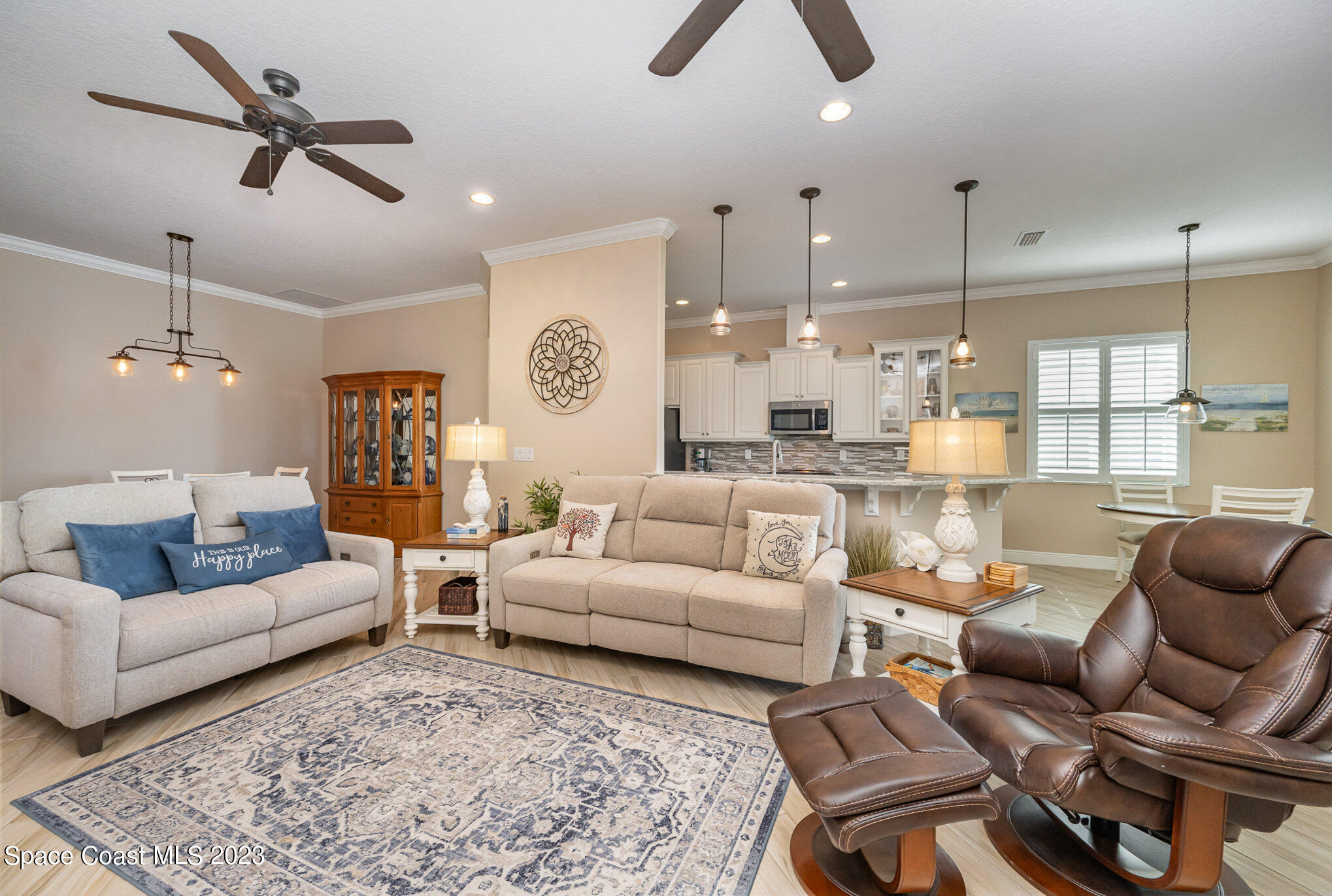 3850 Alamanda Key Drive Melbourne, FL 32901 - Photo 44 of 44 a living room with furniture kitchen view and a chandelier