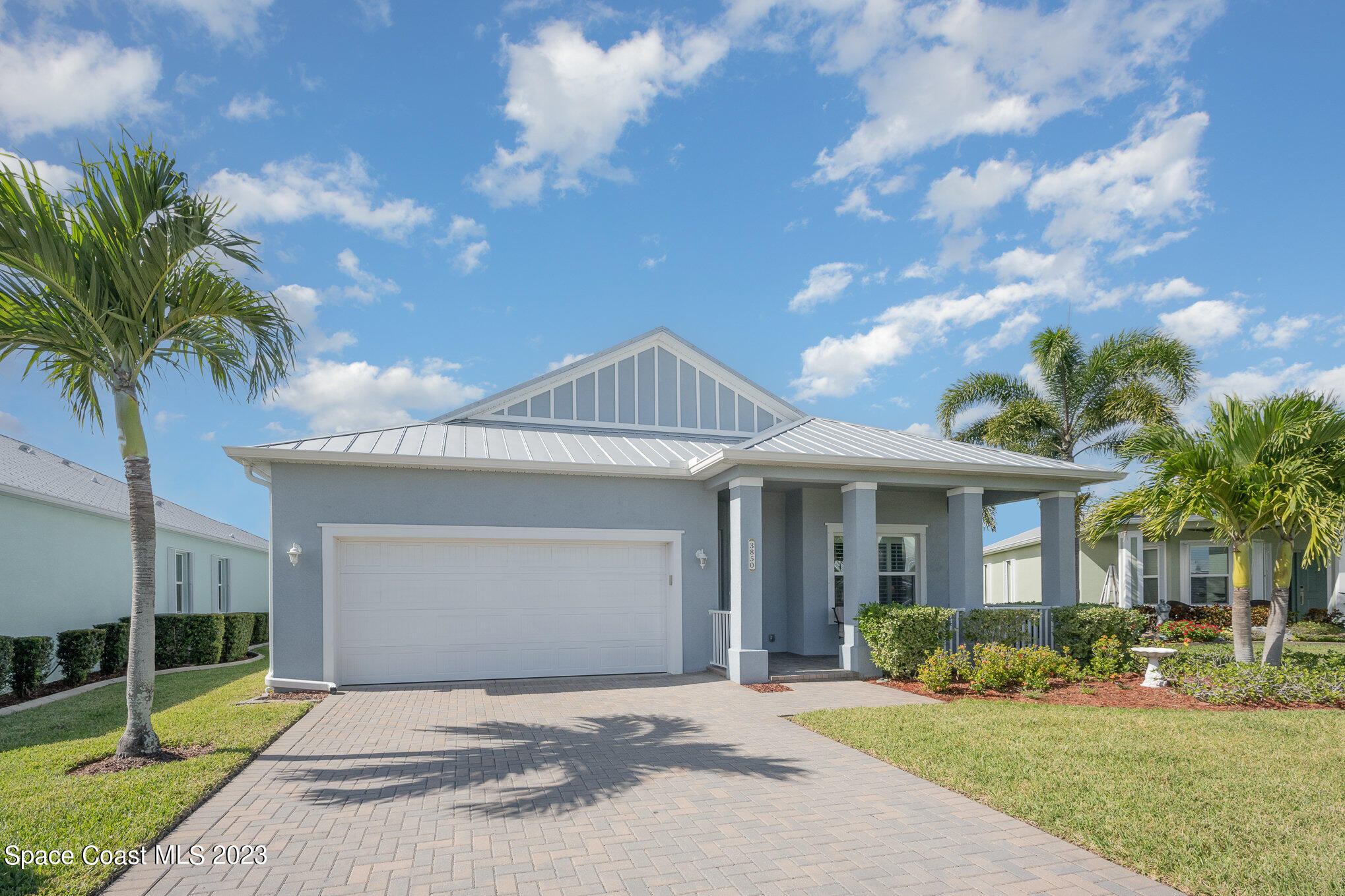 3850 Alamanda Key Drive Melbourne, FL 32901 - Photo 20 of 44 a front view of a house with a yard and potted plants