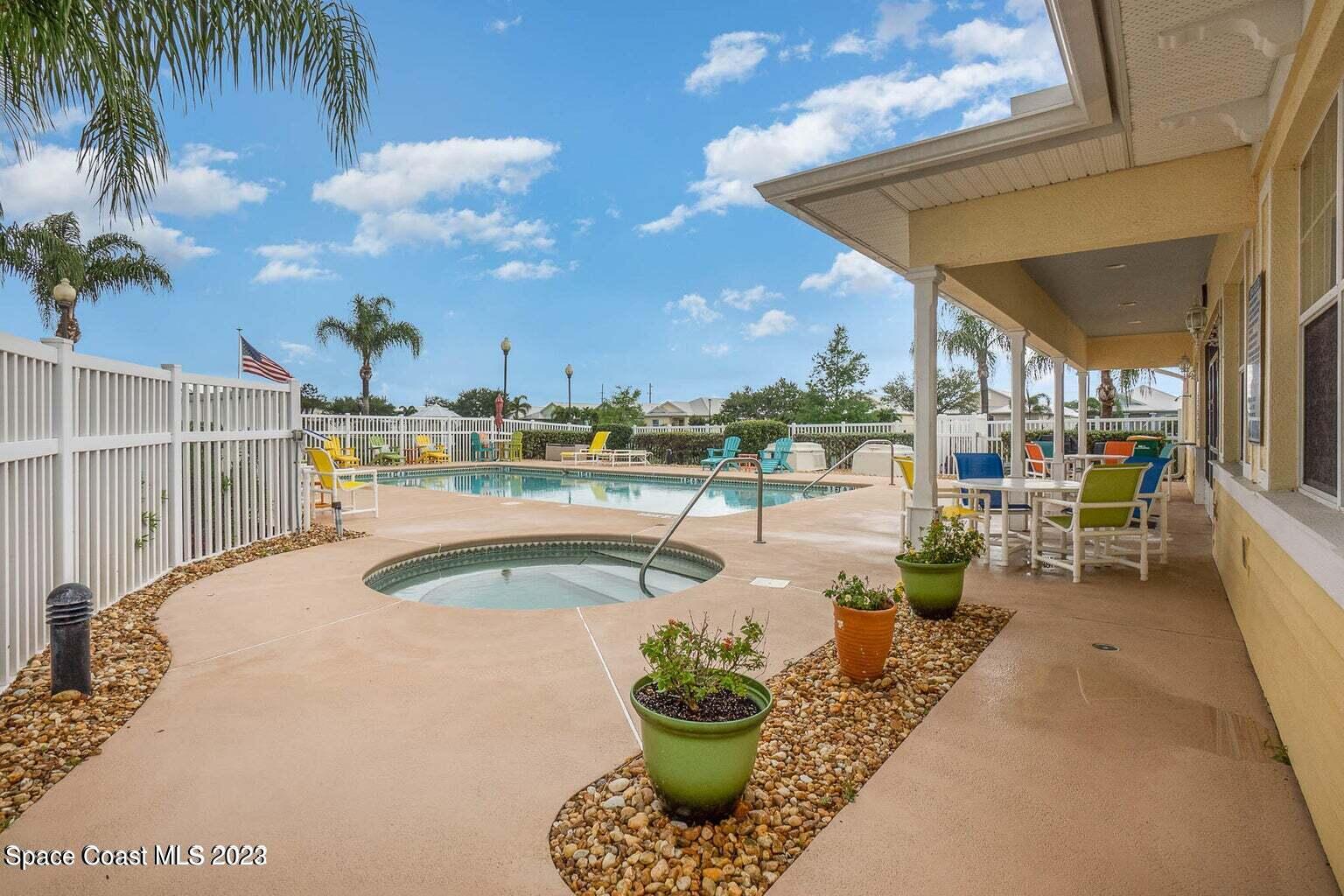 3850 Alamanda Key Drive Melbourne, FL 32901 - Photo 25 of 44 a view of a swimming pool with a patio and a tub
