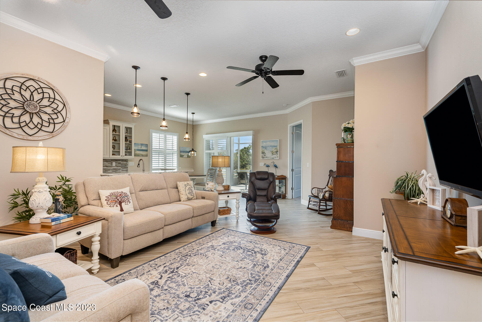 3850 Alamanda Key Drive Melbourne, FL 32901 - Photo 2 of 44 a living room with furniture and a flat screen tv