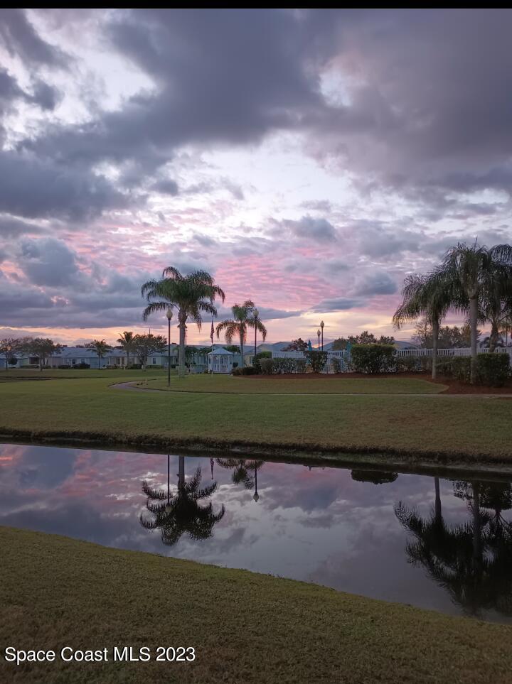 3850 Alamanda Key Drive Melbourne, FL 32901 - Photo 42 of 44 a view of a lake in front of a house with a yard