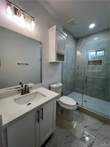 a bathroom with a sink toilet and shower