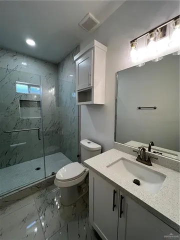 a bathroom with a sink toilet and shower