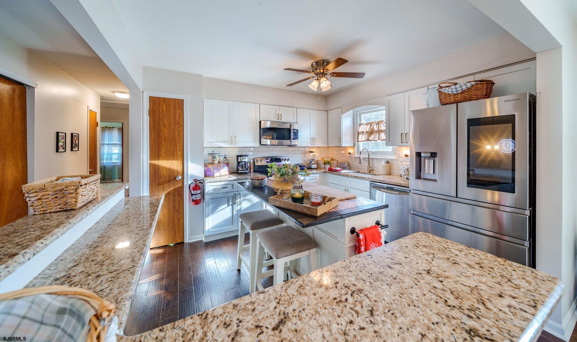 68 Defeo Lane Somers Point, NJ 08244 - Photo 11 of 51 a living room with stainless steel appliances kitchen island granite countertop furniture and a kitchen view