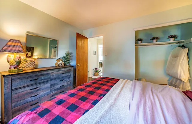 a bedroom with a bed and a dresser in it