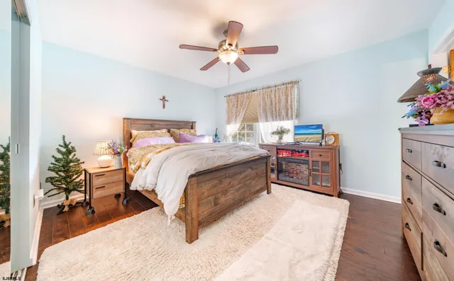a bed room with a bed and a ceiling fan