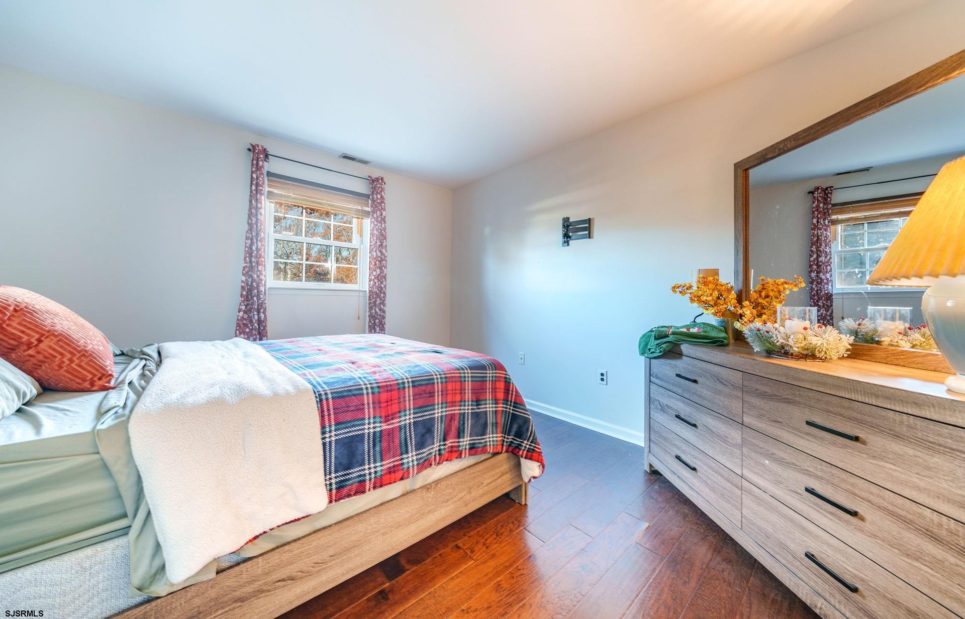 68 Defeo Lane Somers Point, NJ 08244 - Photo 21 of 51 a bedroom with a bed and wooden floor