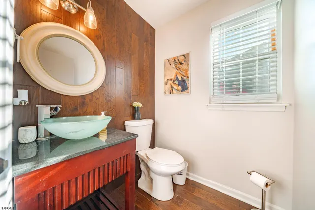 a bathroom with a toilet a sink and a mirror