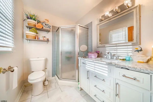 a bathroom with a sink a vanity and a toilet