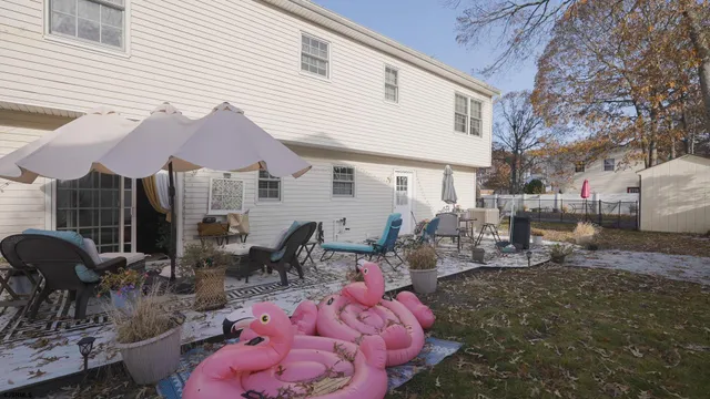 a group of people sitting in front of a house