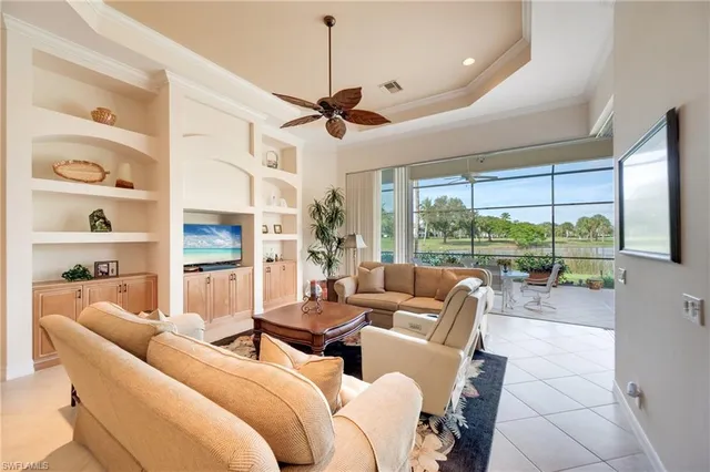a living room with furniture large windows and flat screen tv