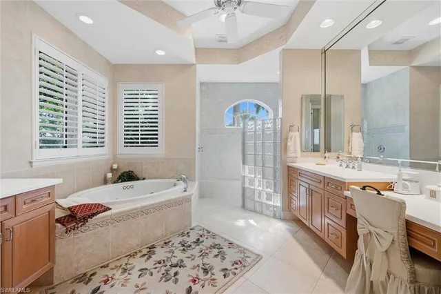 a bathroom with a tub sink and mirror