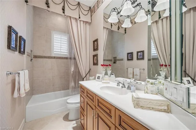 a bathroom with a granite countertop sink a toilet and a bathtub