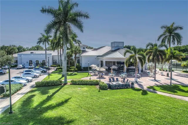 a view of a house with backyard and sitting area