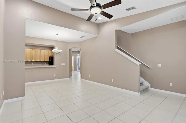 a view of an empty room with a ceiling fan