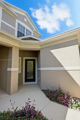 a front view of a house with a flower garden