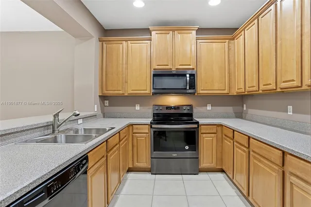 a kitchen with a sink stove and microwave