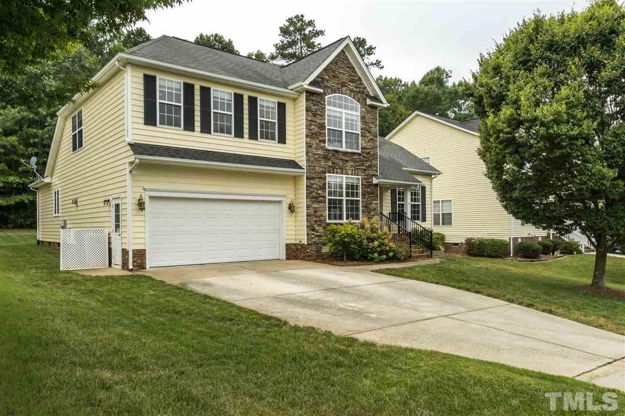 228 Mickleson Ridge Drive Raleigh, NC 27603 - Photo 2 of 25 a front view of a house with a yard and garage