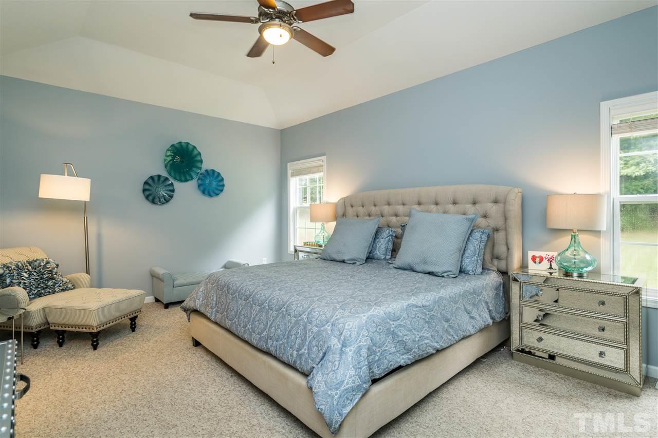 228 Mickleson Ridge Drive Raleigh, NC 27603 - Photo 12 of 25 a bedroom with a bed and a window