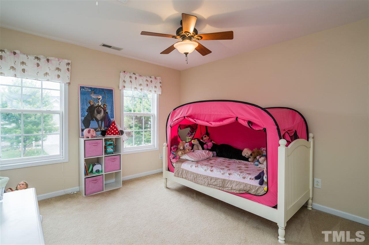 228 Mickleson Ridge Drive Raleigh, NC 27603 - Photo 14 of 25 a bedroom with a bed and a window