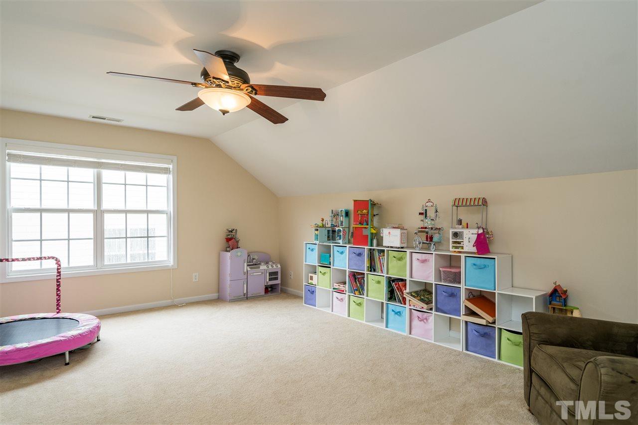 228 Mickleson Ridge Drive Raleigh, NC 27603 - Photo 15 of 25 a view of room with toys and ceiling fan