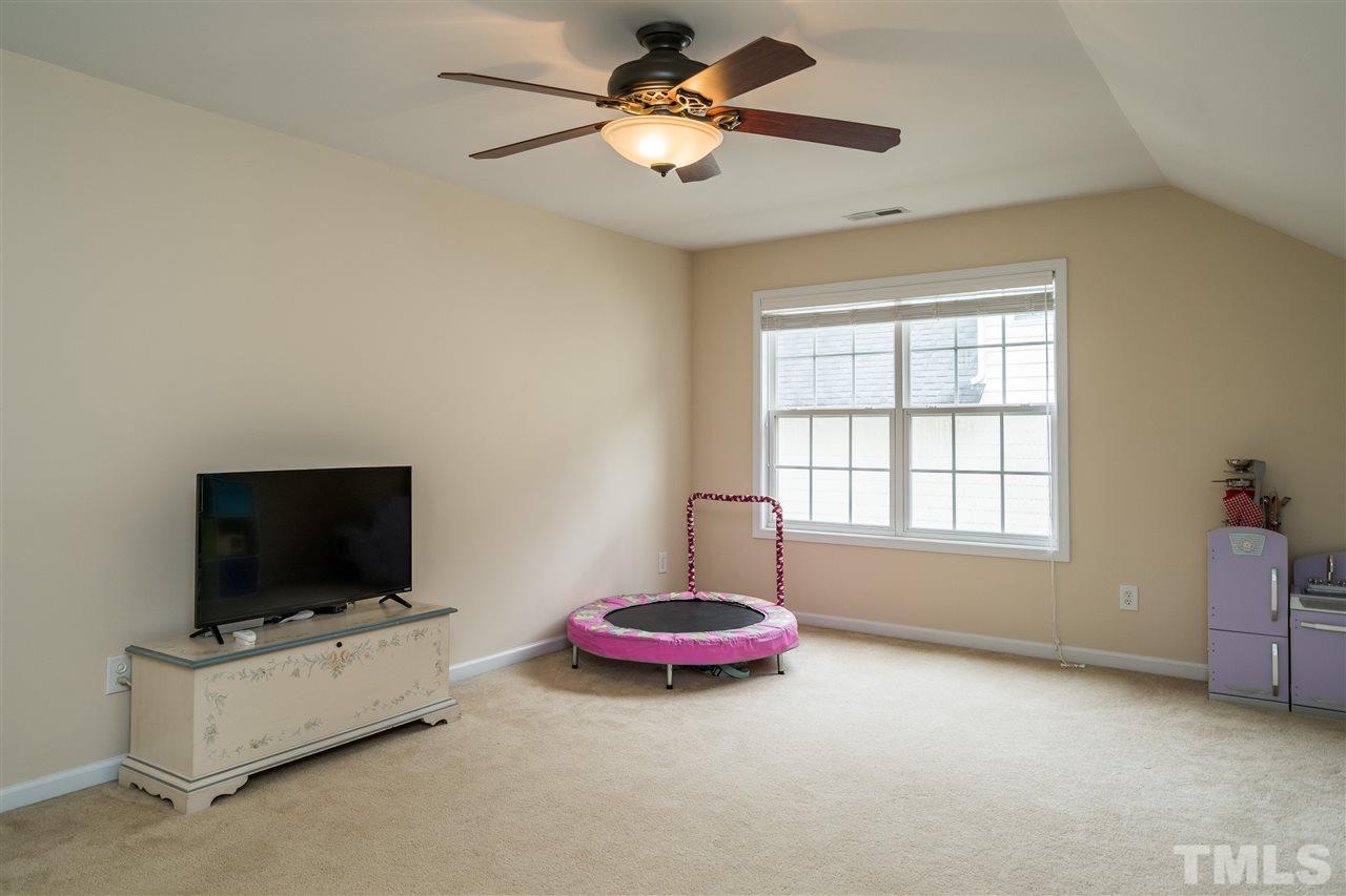 228 Mickleson Ridge Drive Raleigh, NC 27603 - Photo 16 of 25 a living room with furniture and a flat screen tv