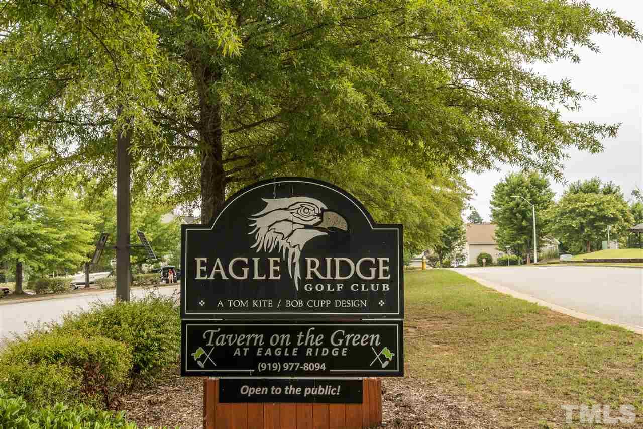 228 Mickleson Ridge Drive Raleigh, NC 27603 - Photo 21 of 25 a view of a street sign under a large tree