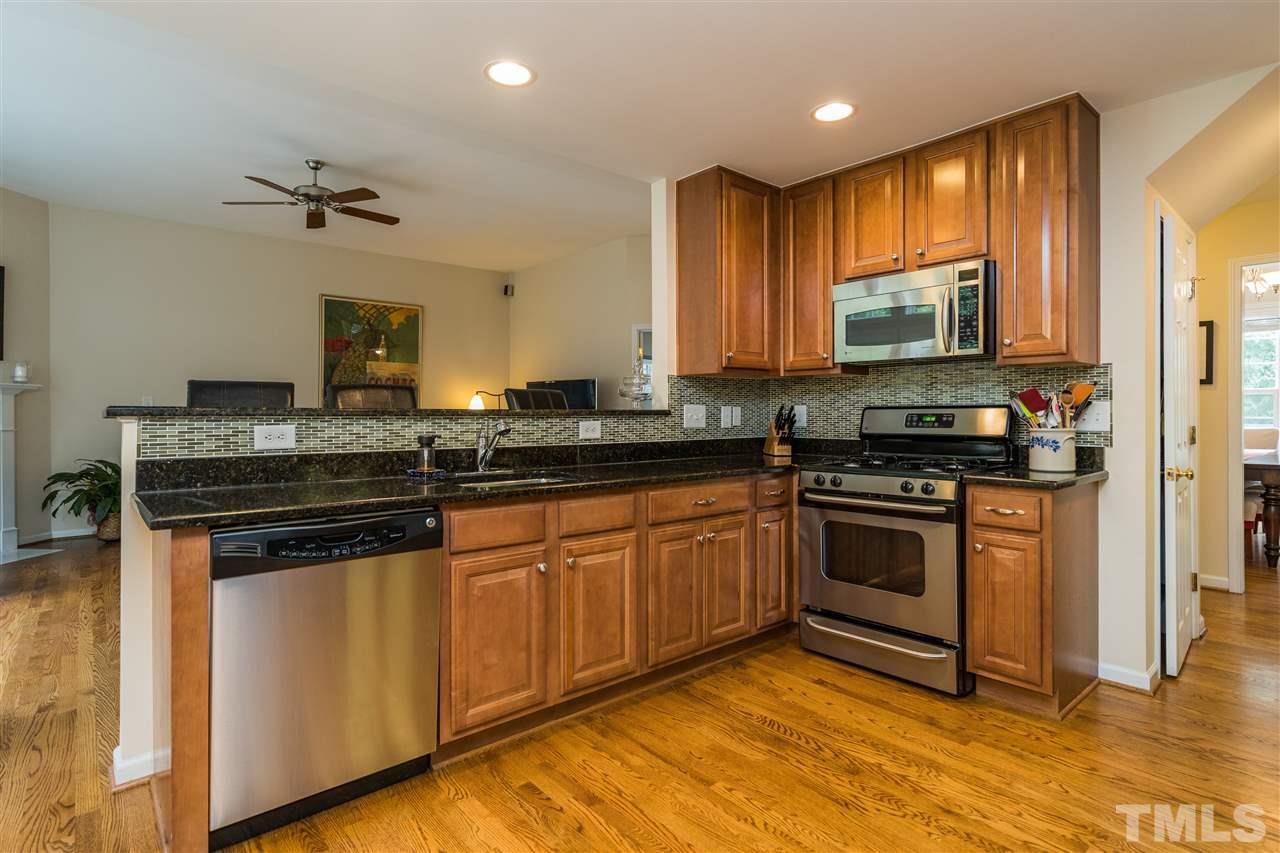 228 Mickleson Ridge Drive Raleigh, NC 27603 - Photo 6 of 25 a kitchen with stainless steel appliances granite countertop a stove a sink and a microwave