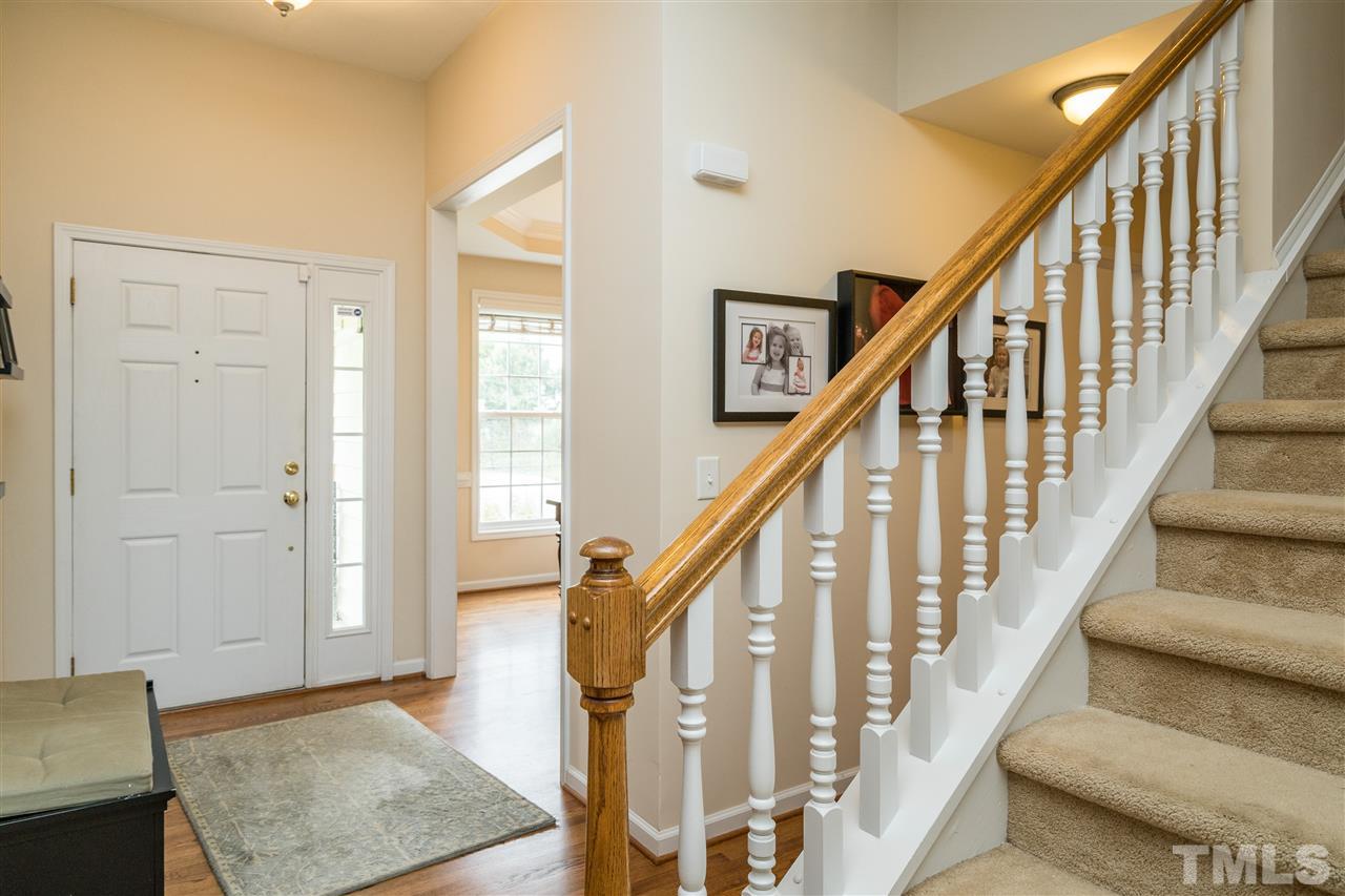 228 Mickleson Ridge Drive Raleigh, NC 27603 - Photo 9 of 25 a view of staircase with wooden floor and a rug