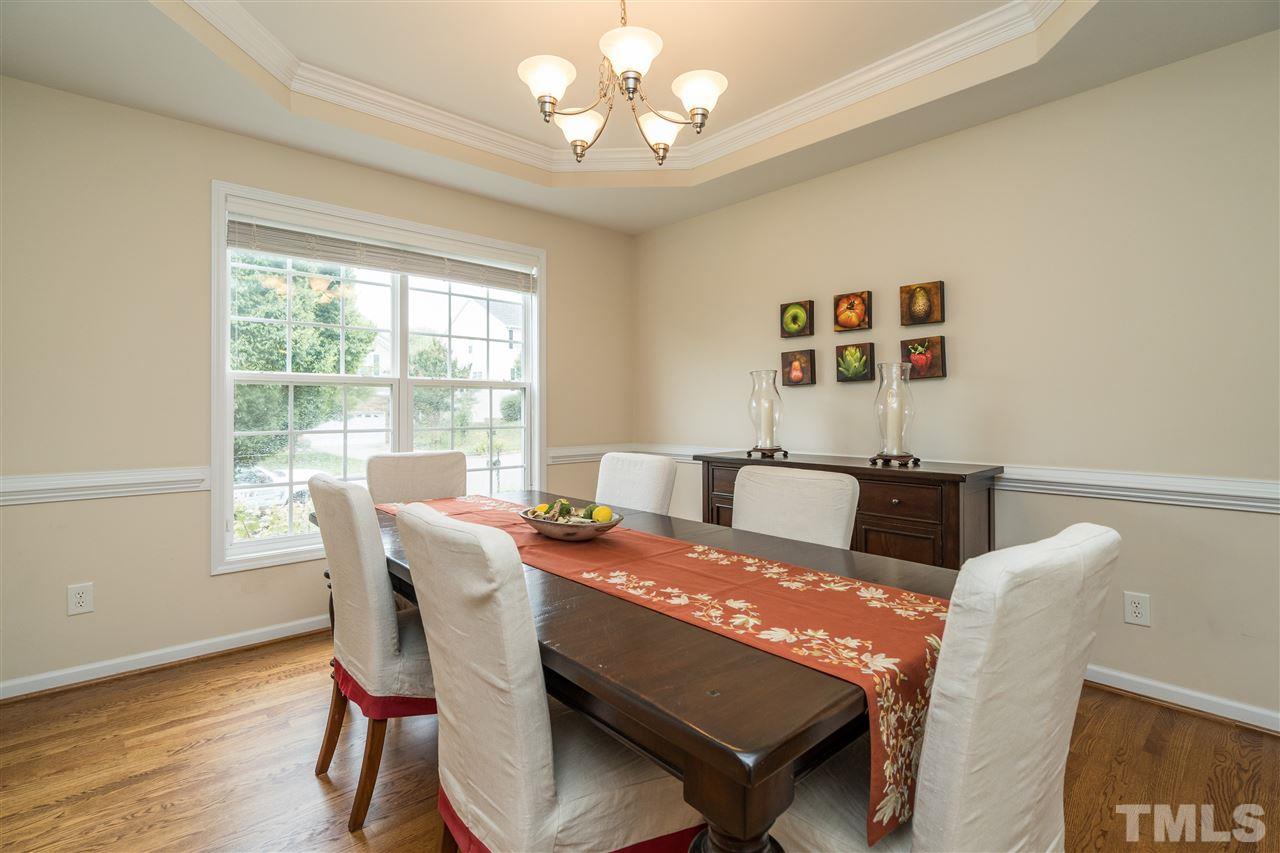 228 Mickleson Ridge Drive Raleigh, NC 27603 - Photo 10 of 25 a view of a dining room with furniture window and wooden floor