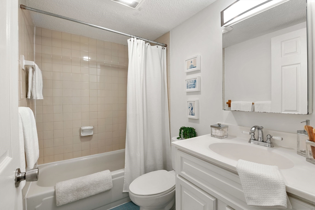 135 Pleasant Street, Unit 403 Brookline, MA 02446 - Photo 11 of 18 a bathroom with a sink toilet and shower