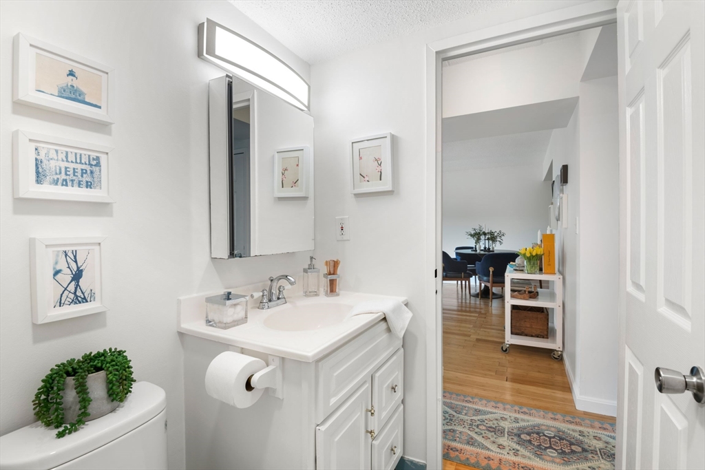 135 Pleasant Street, Unit 403 Brookline, MA 02446 - Photo 12 of 18 a bathroom with a sink and a mirror