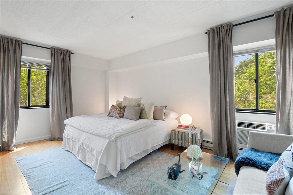 135 Pleasant Street, Unit 403 Brookline, MA 02446 - Photo 7 of 18 a bedroom with a bed and a window