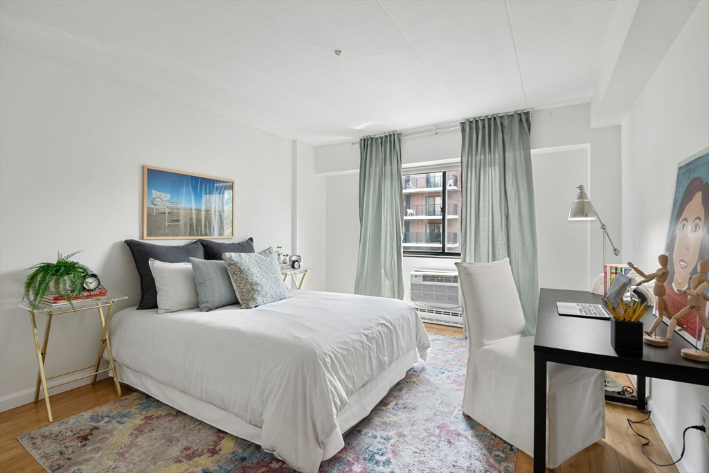 135 Pleasant Street, Unit 403 Brookline, MA 02446 - Photo 9 of 18 a bed room with a bed and a chair