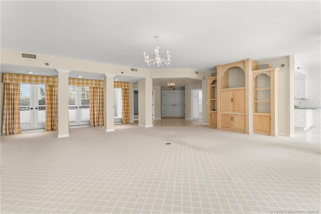 3001 Southeast Island Point Lane, Unit 14 Stuart, FL 34996 - Photo 3 of 38 a view of an empty room with glass door