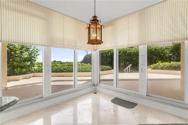 a view of an empty room with furniture and windows