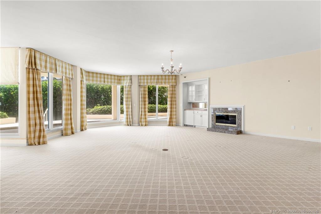 3001 Southeast Island Point Lane, Unit 14 Stuart, FL 34996 - Photo 9 of 38 a view of an empty room with furniture and windows