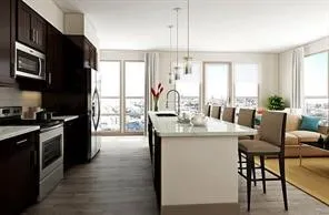 a kitchen with stainless steel appliances granite countertop a stove and a refrigerator