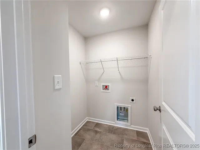 a view of walk in closet with clothes