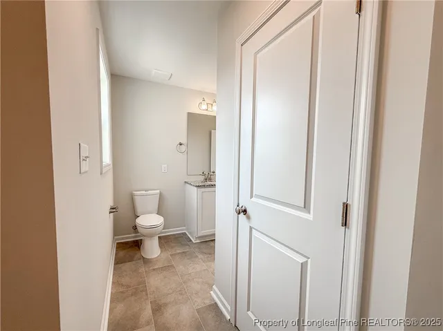 a white toilet sitting next to a bathroom sink