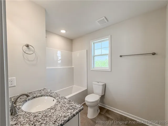 a bathroom with a sink toilet and a mirror