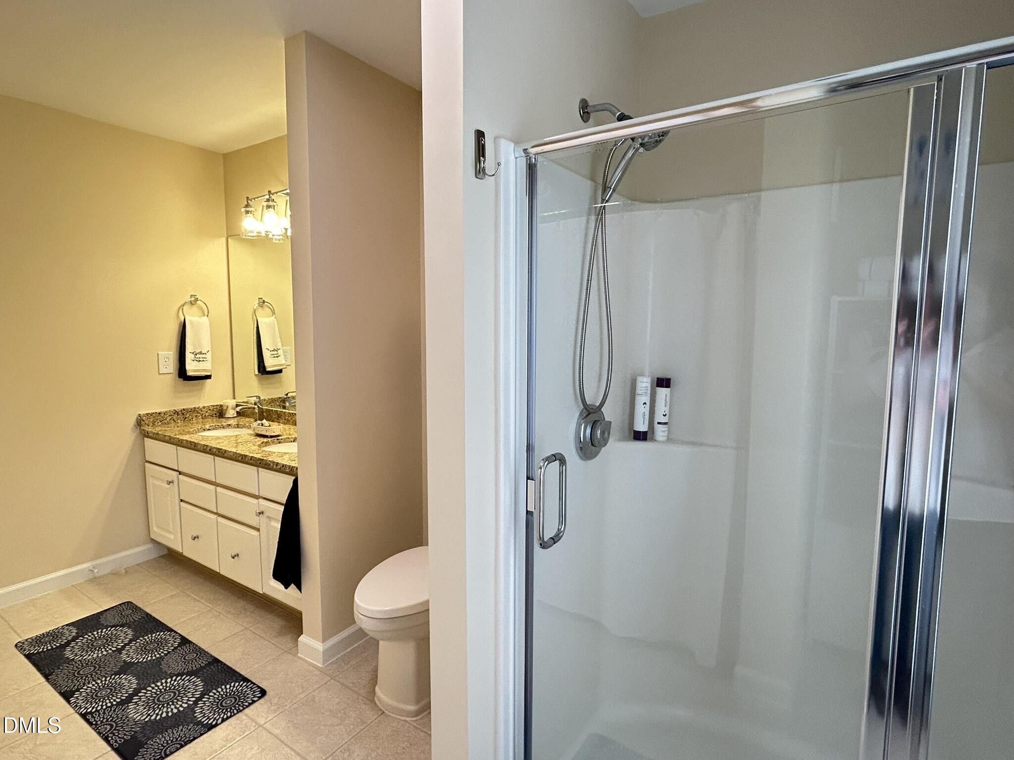 2510 Friedland Place, Unit 102 Raleigh, NC 27617 - Photo 36 of 42 a bathroom with a granite countertop sink toilet and shower