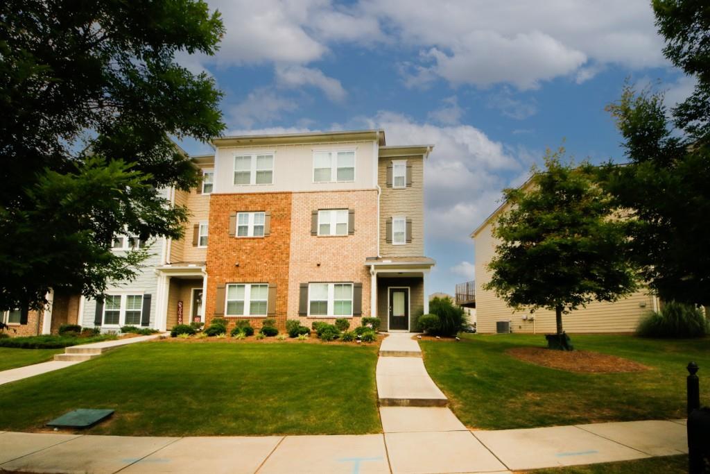 a front view of a house with a yard