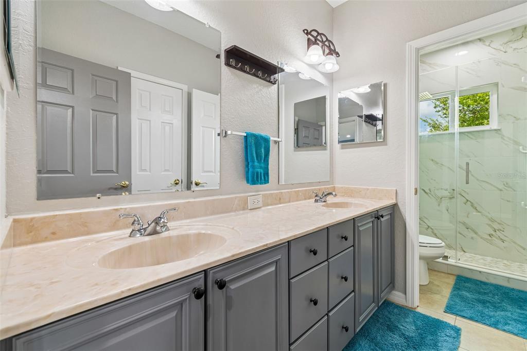 11830 Newberry Grove Loop Riverview, FL 33579 - Photo 26 of 58 a bathroom with a granite countertop sink a toilet and a mirror