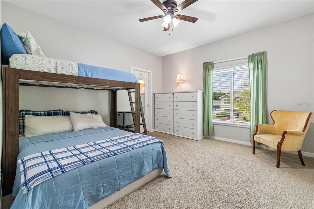 11830 Newberry Grove Loop Riverview, FL 33579 - Photo 28 of 58 a bedroom with a bed and a chandelier