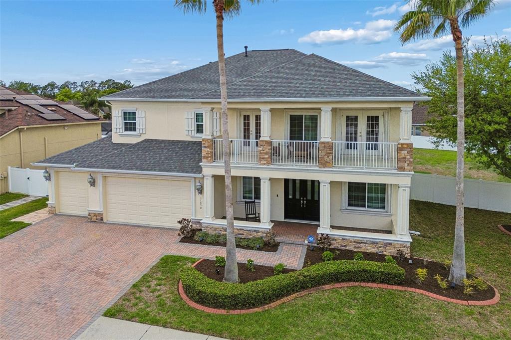 11830 Newberry Grove Loop Riverview, FL 33579 - Photo 3 of 58 a front view of a house with garden